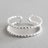 Twisted beads CZ ring in 925 sterling silver, adjustable design, showcasing intricate detailing and sparkling stones.