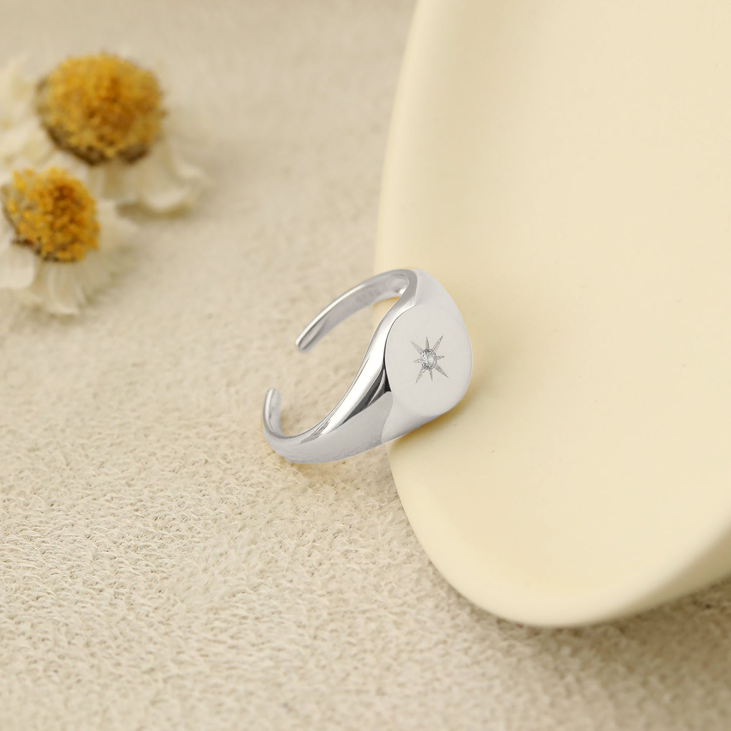 CZ Sonnenstern Ring aus 925er Silber, verstellbar, funkeldesign mit eleganten Details, auf einem neutralen Hintergrund.